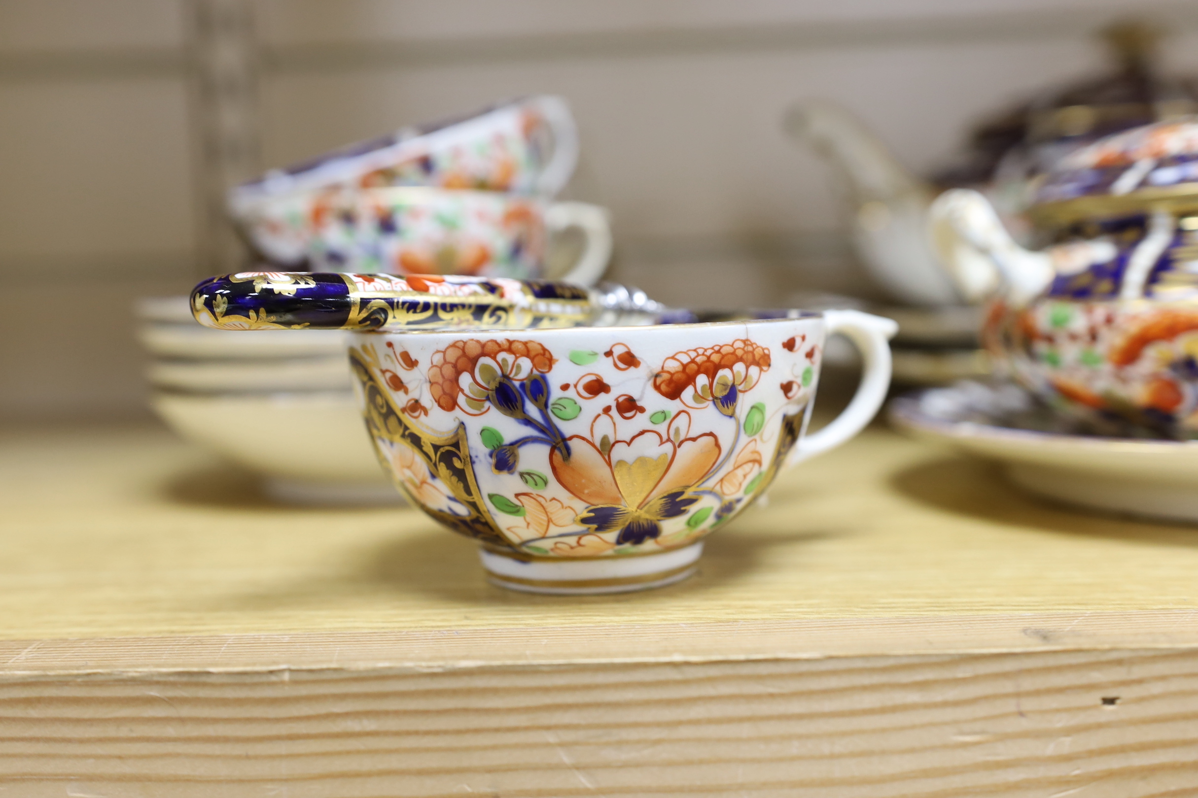 A mid 19th century Derby Imari pattern tea service, comprising a pair of two handled cake plates, a teapot on stand, a sucrier, a cream jug, a bowl and cover, three cups and four saucers, NB: From the Estate of Rt Hon Lo